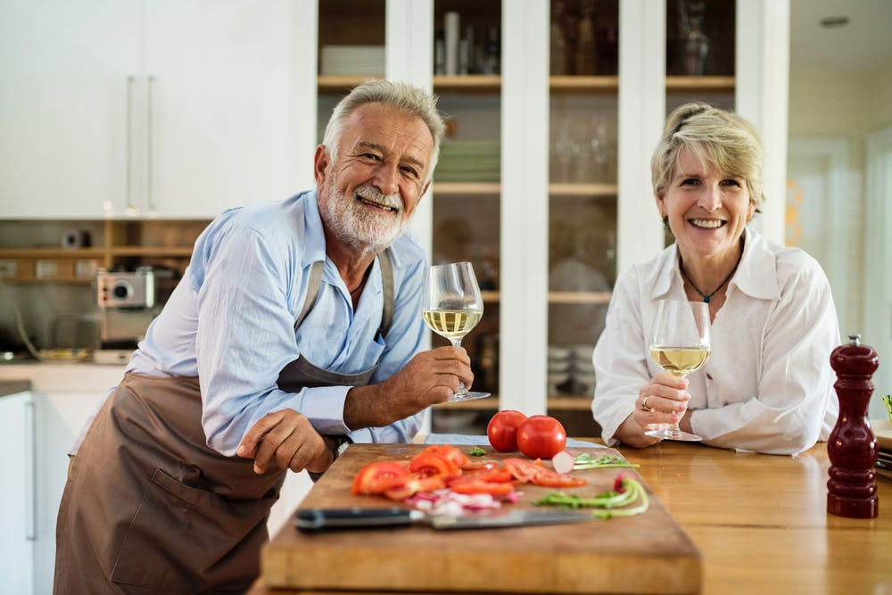 Senior man and woman holding wine glasses